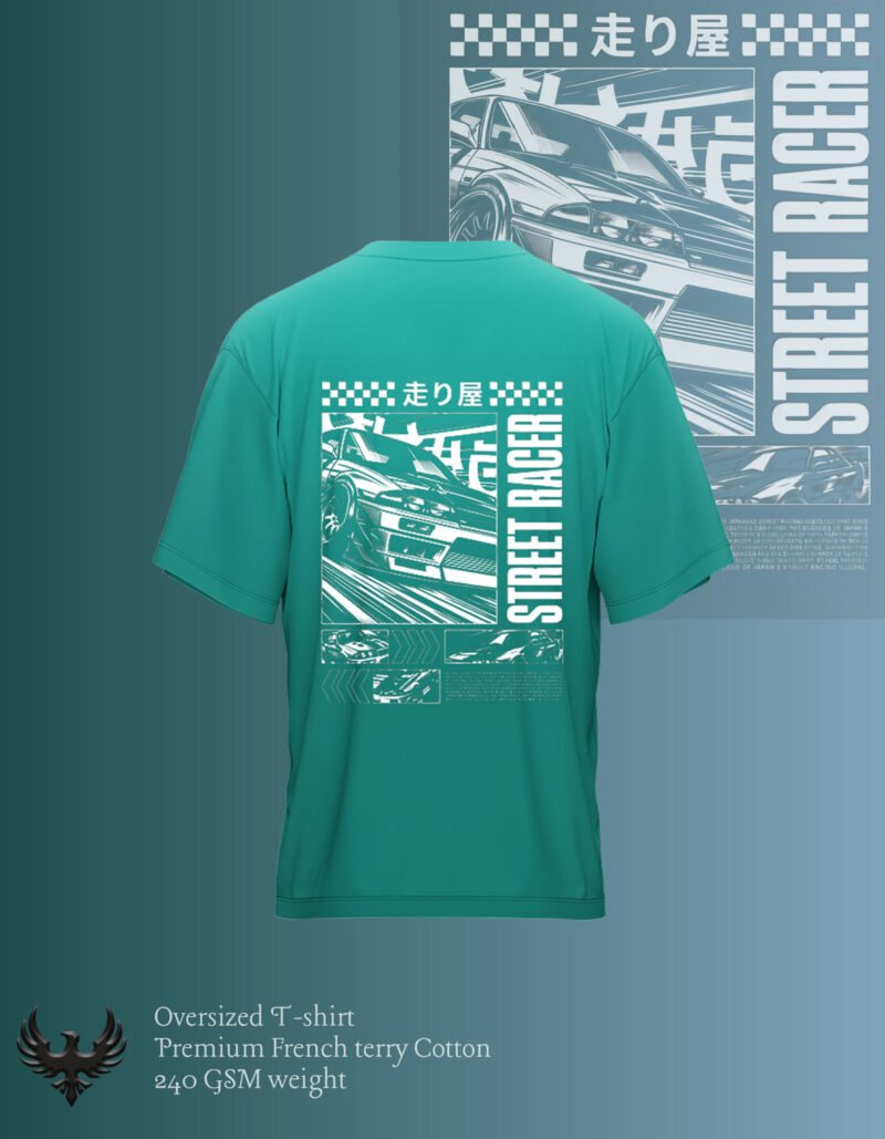 "Green oversized T-shirt with a bold back print design featuring a speeding street car, Japanese text, and the words 'STREET RACER' in large vertical white typography over a checkered background."